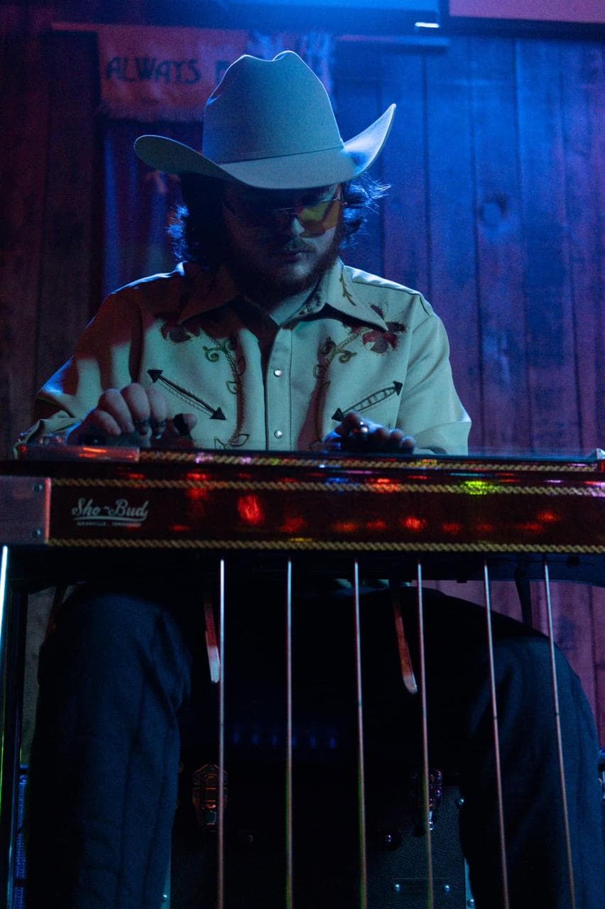 Sam Shoemaker playing pedal steel guitar in a cowboy hat