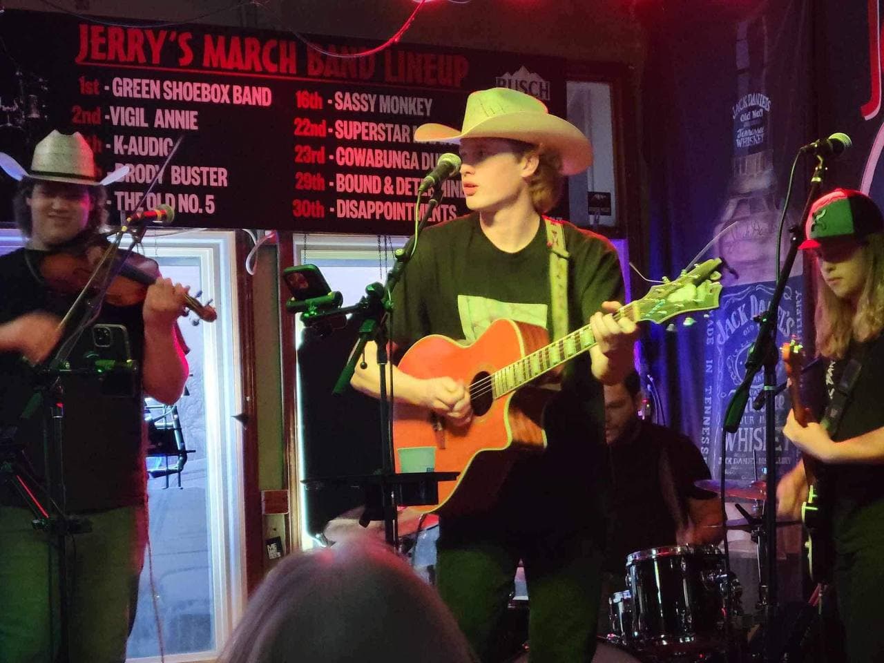 A young country band performing onstage at Country Jam