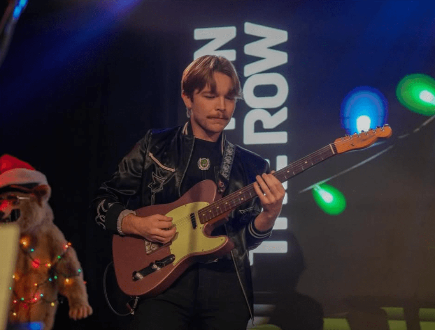 Nate Gregory playing guitar onstage